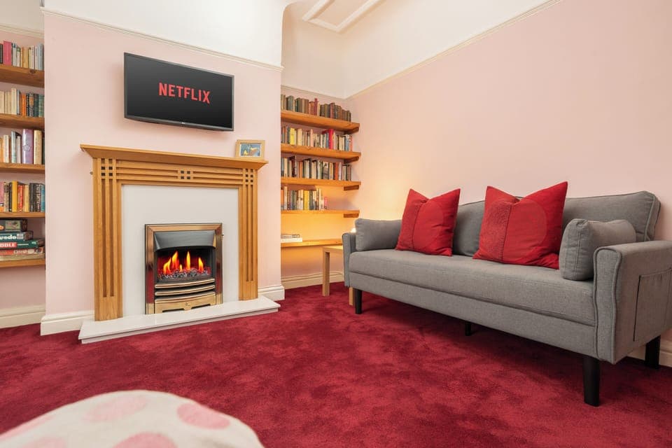 Step into a warm and welcoming living room designed for comfort and connection. Sink into one of the two plush sofas by the fireplace, enjoy a film on the Smart TV, or unwind with a board game or a good book from the cosy in-house library.