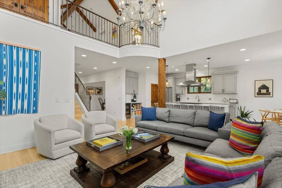 Living Room with TV, Gas Fireplace and High Ceilings Open to Kitchen