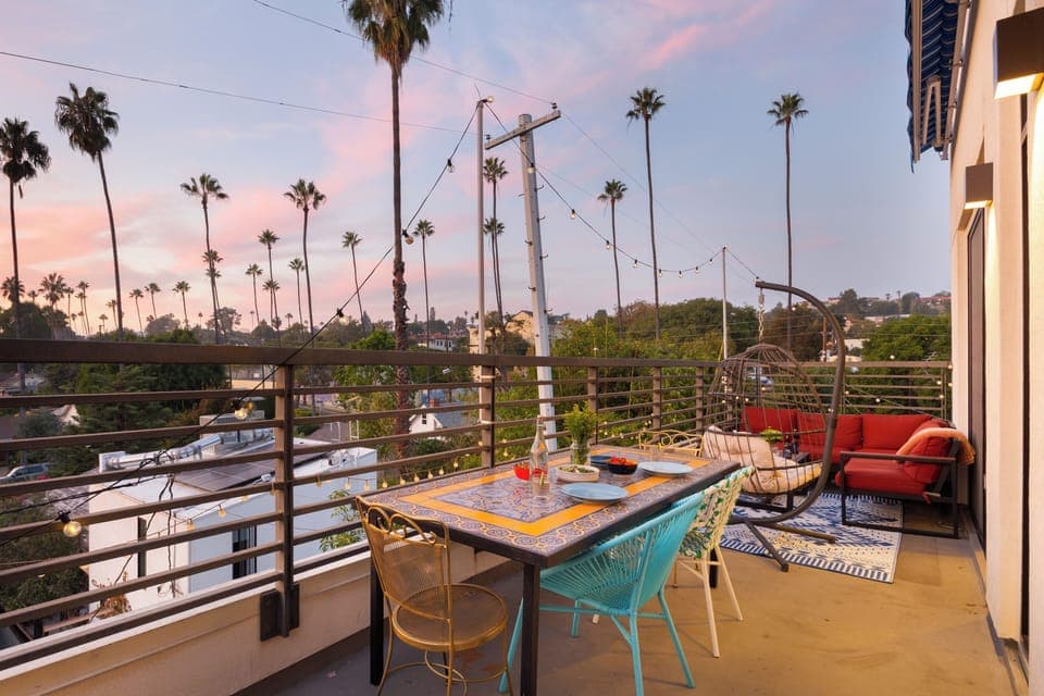 Balcony with dining table and outdoor living set.