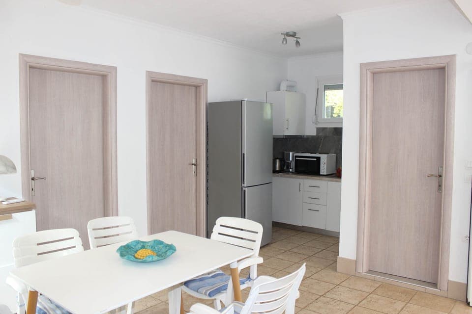 Spacious layout combining dining and living areas, perfect for couples or small families on a seaside getaway.