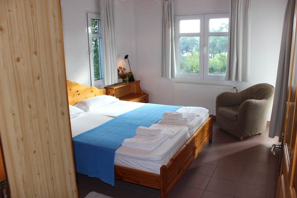 Fresh and cozy room with quality bedding and garden views for a rejuvenating night’s sleep.