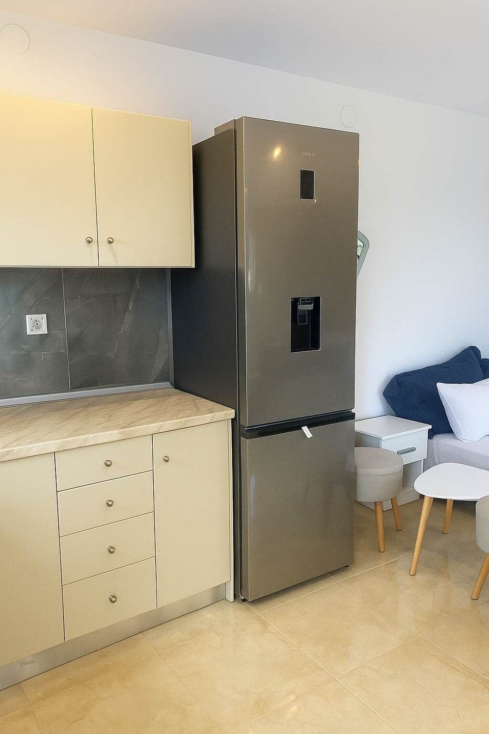 Clean and convenient kitchen with stovetop, fridge, for relaxed seaside living.