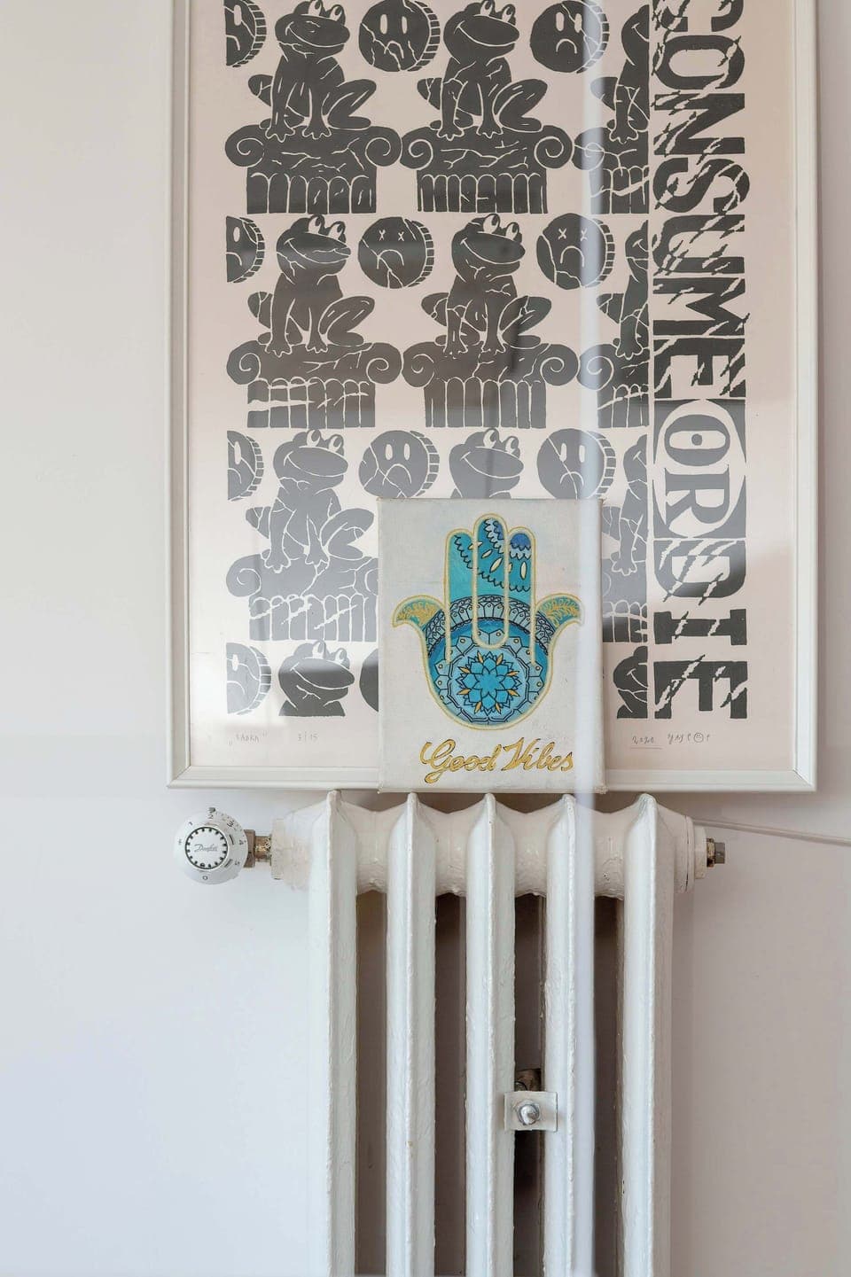 A decorative wall element with an abstract design and modern radiator below. The minimalist decor adds artistic flair.