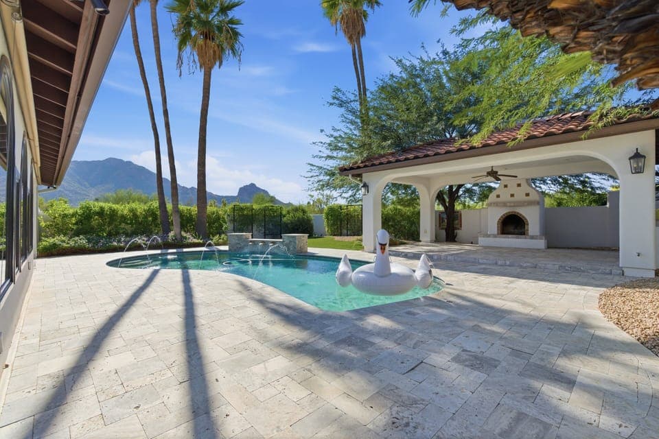 Outdoor oasis featuring a sparkling pool, pergola with built-in BBQ grill. *Fireplace for display only.