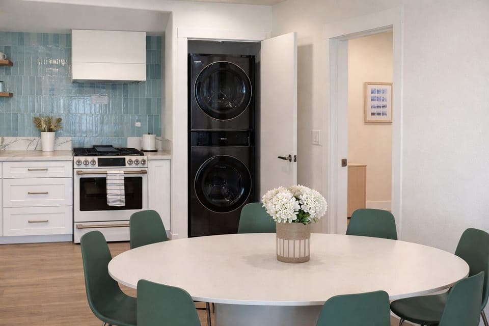 Gather around your spacious dining table while meals cook nearby. Modern kitchen and convenient in-unit laundry make your stay effortless.