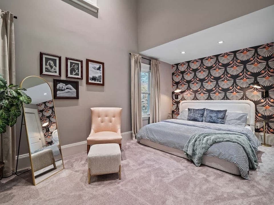 - Chic primary bedroom with bold designer wallpaper - Plush bedding and relaxing ambiance for comfort - Spacious retreat ideal for couples and guests