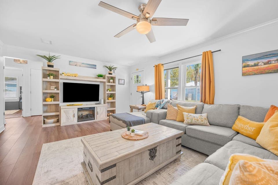 Bright and spacious living room designed for comfort and connection. Relax on a cozy sectional, enjoy movie nights on the large TV, or gather with family and friends in this inviting open-concept space after a day of exploring