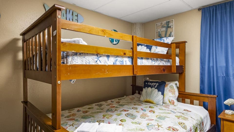 This bedroom features a Twin-over-Full bunk bed for flexible sleeping arrangements
