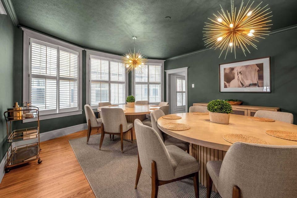 Graceful dining nook highlighted by sculptural light fixtures, earthy tones, and sunlit windows, creating a peaceful place to unwind and enjoy good company.