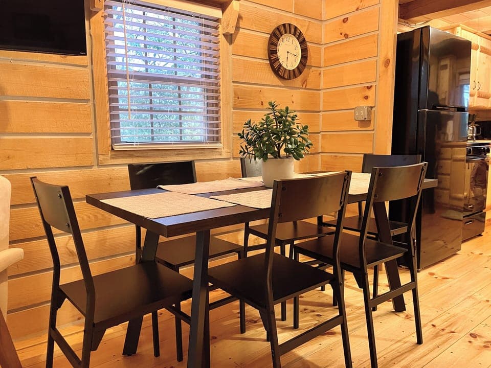 🍽️ Gather and share meals or laughter at this cozy dining table, perfect for family dinners and game nights in your log cabin retreat!