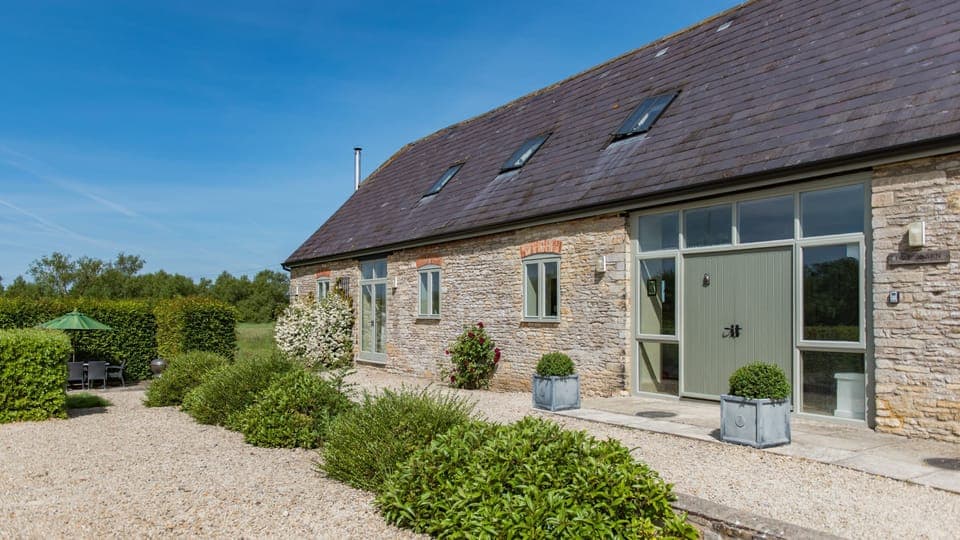 Just outside is a private dining terrace with a table and chairs and a charcoal barbecue.