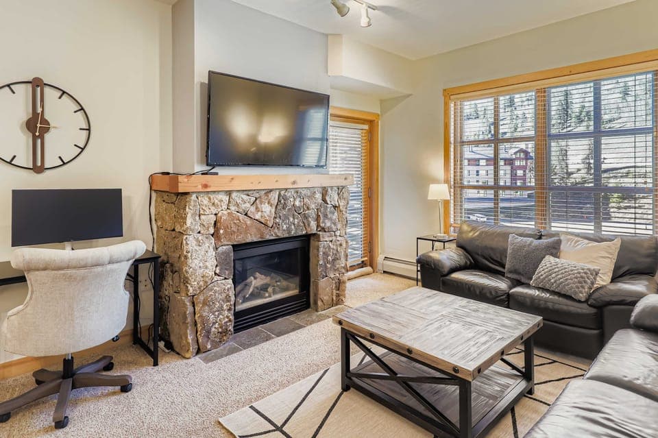 Living Room, plenty of seating, fireplace, desk for work area