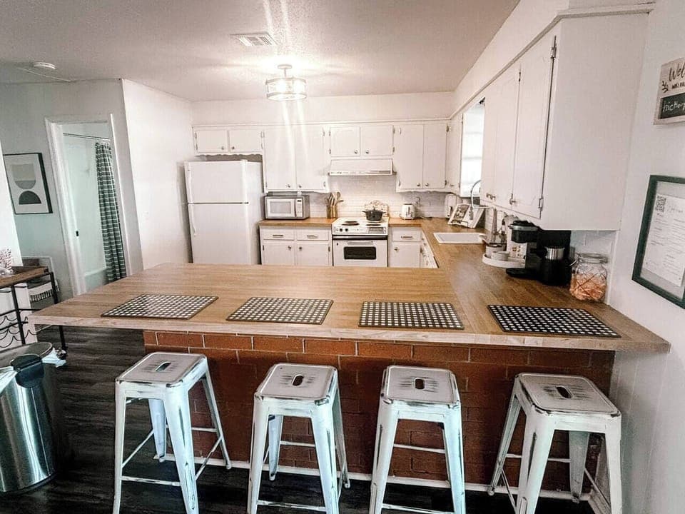 Fully stocked kitchen with all essentials, keurig coffee station, and basic cooking spices and oil