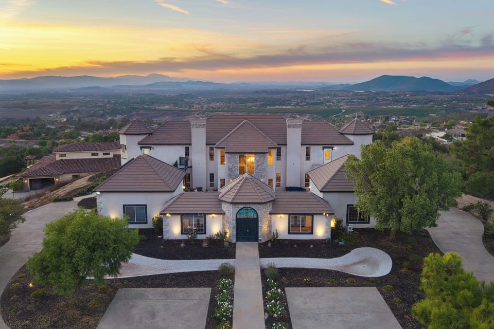 Aerial exterior view of the home at sunset.