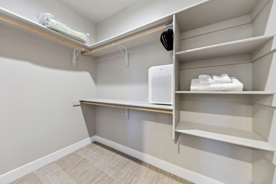 Primary walk in closet with ample space to keep your belongings organized during your stay.