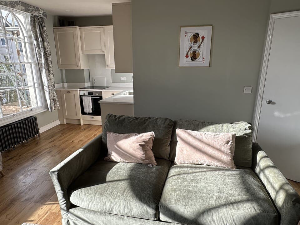 Open plan lounge, dining & kitchen with luxury sofa.com sofabed