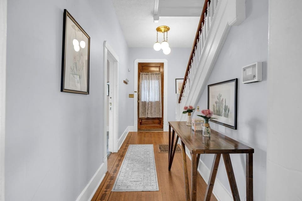 Step into your welcoming entryway with warm hardwood floors, charming decor, and thoughtful touches that make you feel right at home.