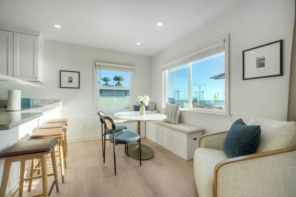 Airy coastal kitchen and dining with scenic views.