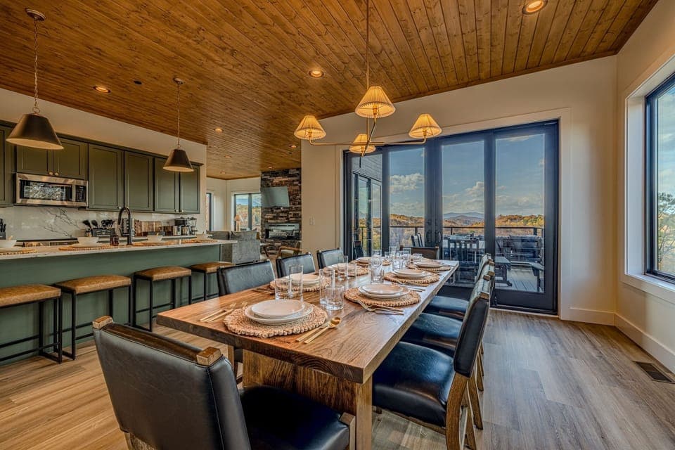Share group meals at the live-edge dining table with a scenic backdrop of the hills
