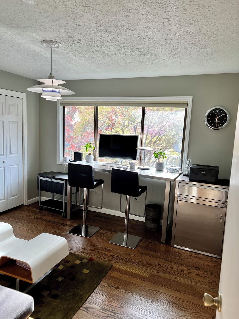 Upstairs office featuring a day bed, two office chairs, and a large WFH area