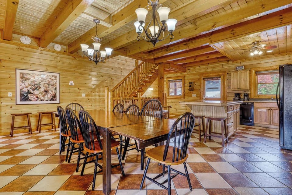 Gather around a handcrafted table beneath rustic beams in this inviting space!