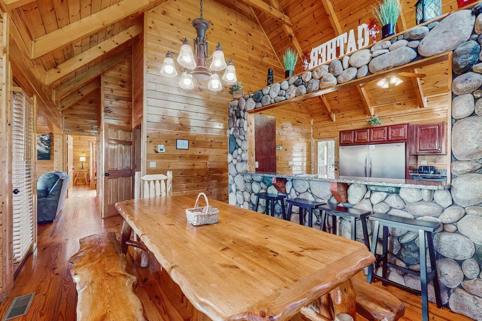 Gather around a stunning handcrafted table with scenic views and warm wood finishes!