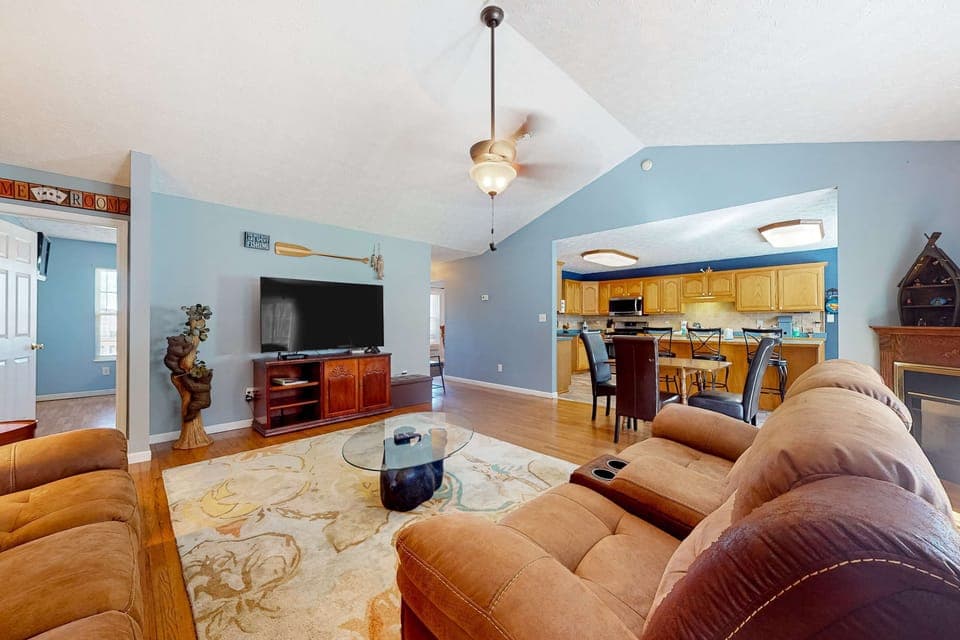 Relax in style with spacious seating, a large TV, and a charming view of the kitchen!