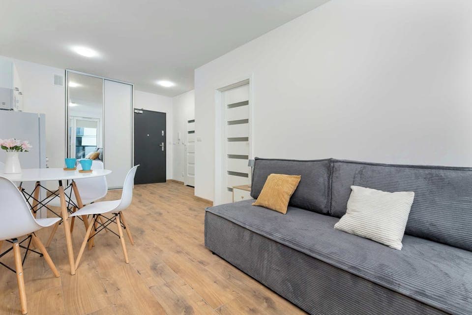 Relax in the stylish living room with a comfortable sofa and modern decor.