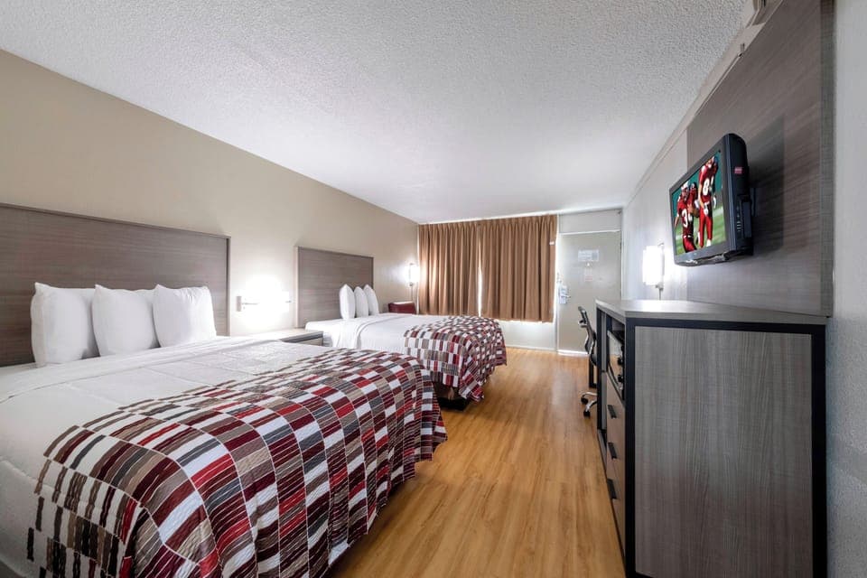 Unwind in a bright double-queen room with comfy bedding.