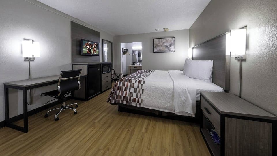 Relax under warm lighting in a calm, modern guestroom.