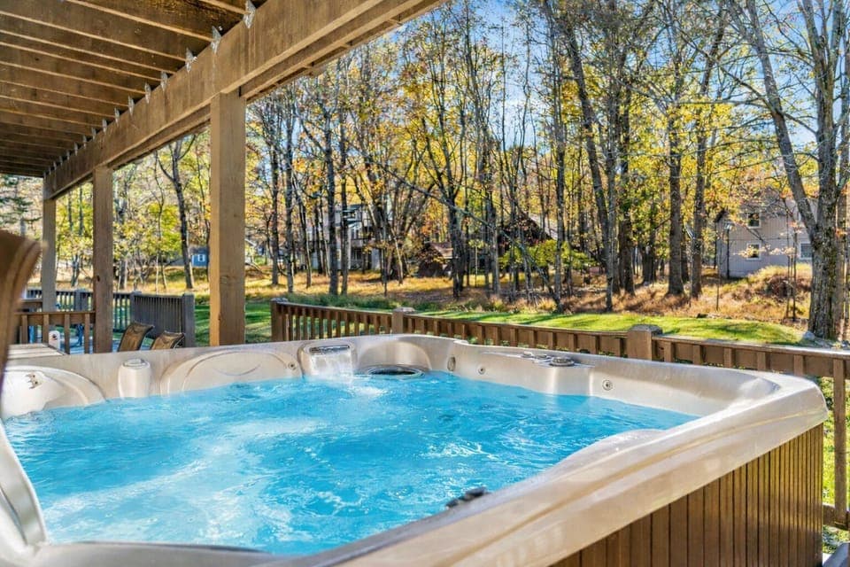 Unwind in the private outdoor hot tub, surrounded by peaceful woods and fresh mountain air—perfect for relaxing after a day of adventure.