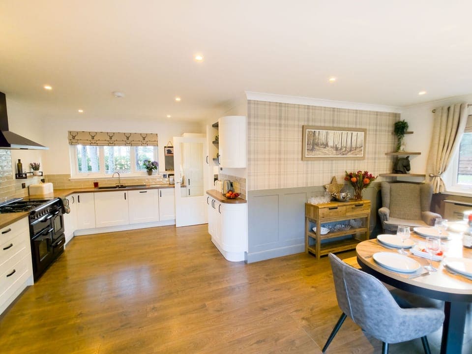 Overview of the spacious kitchen and its connection to the dining area, emphasising the open, social layout.