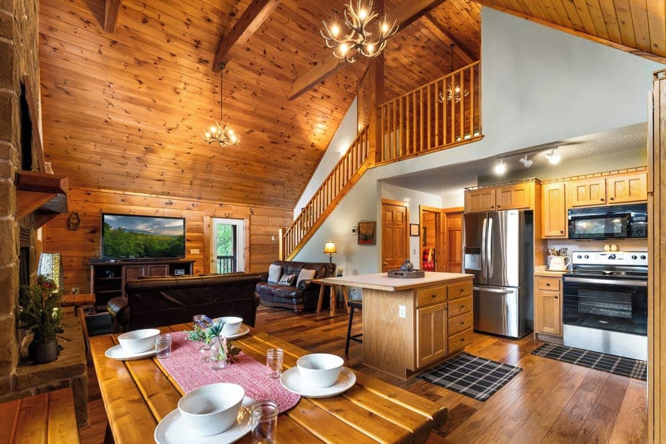 Bright, open-plan living, kitchen, and dining with stunning cabin charm