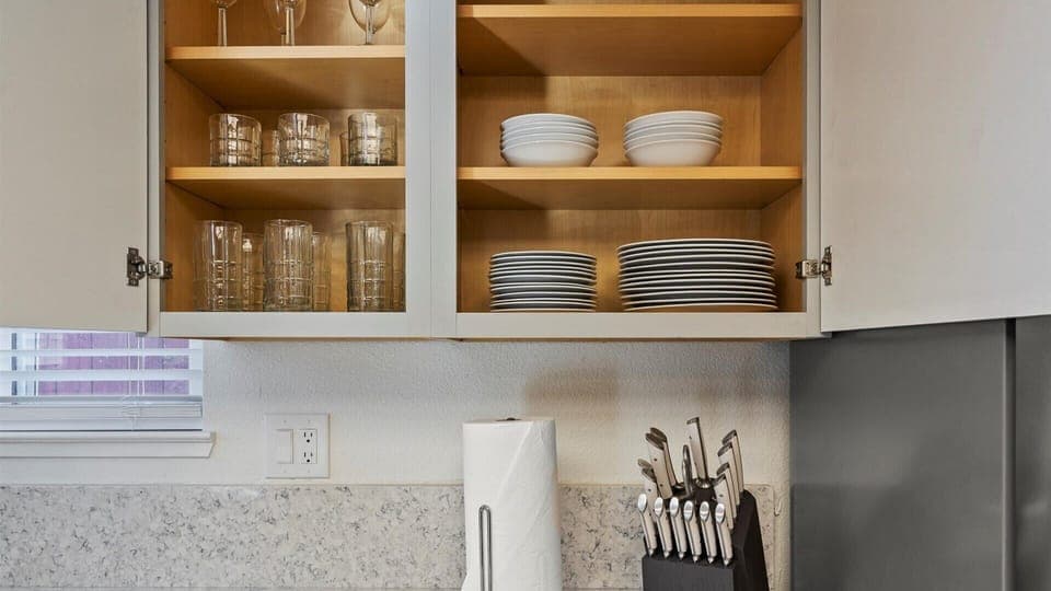 This kitchen is equipped with dishes, glassware, and essential cookware. So you can settle in and dine comfortably, just like home