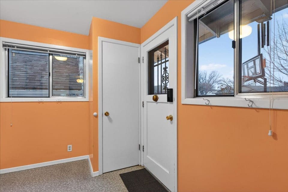 Downstairs entry and full laundry room with washer/dryer