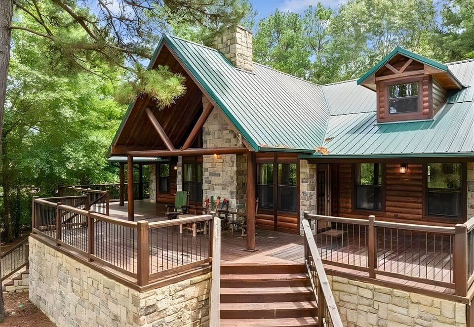 A warm welcome awaits at the front entrance, complete with a wide porch and classic log-cabin details that set the tone for your stay.