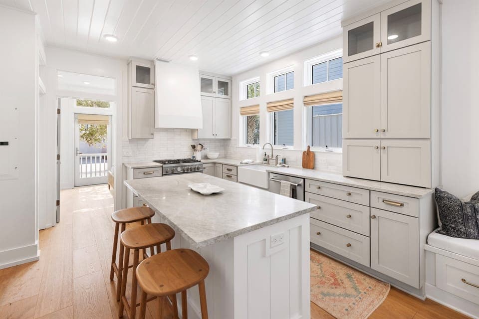 Your gourmet kitchen awaits with marble countertops, chef-grade appliances, and charming bar seating perfect for morning coffee or evening conversations.