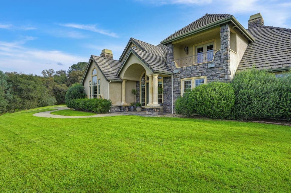 A peaceful hilltop retreat surrounded by green lawns. 