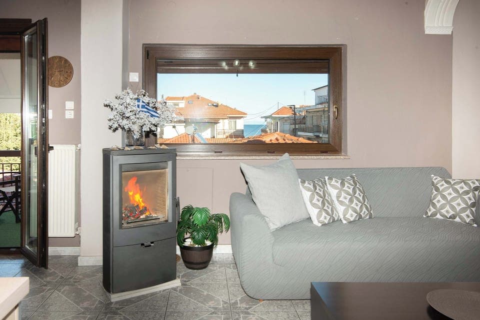 Bright and welcoming living room with comfortable seating, natural light, and relaxing décor — a perfect space to unwind just moments from the beach.