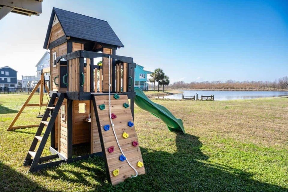 A backyard playset with a stunning lake view for endless fun!