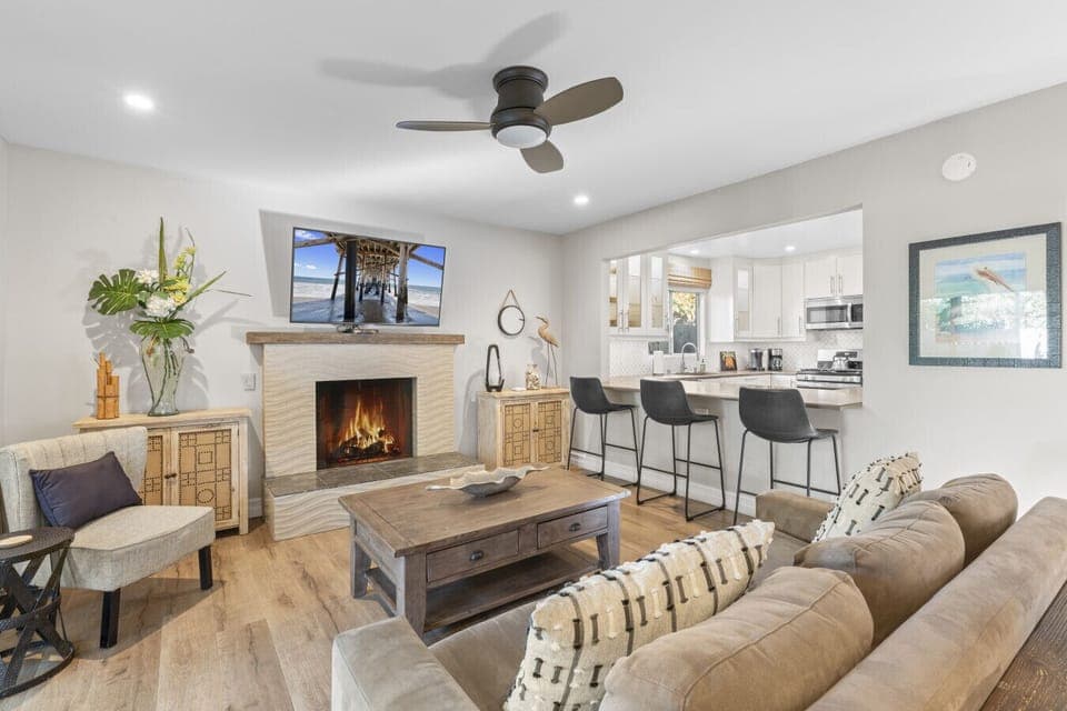 Cozy living space with fireplace and large Smart TV — the perfect place to unwind after the beach.