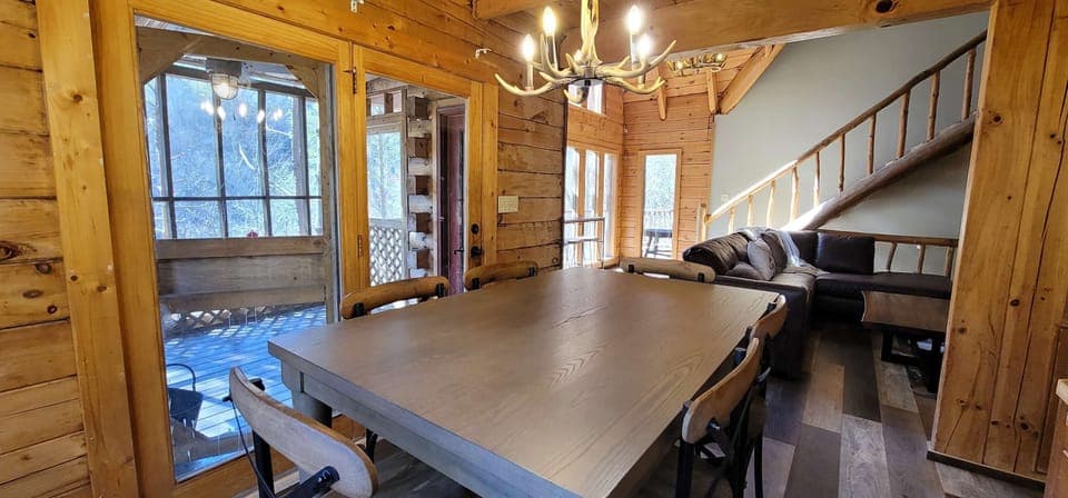 Gather around the rustic table under charming lighting, it's a perfect spot for memorable meals!