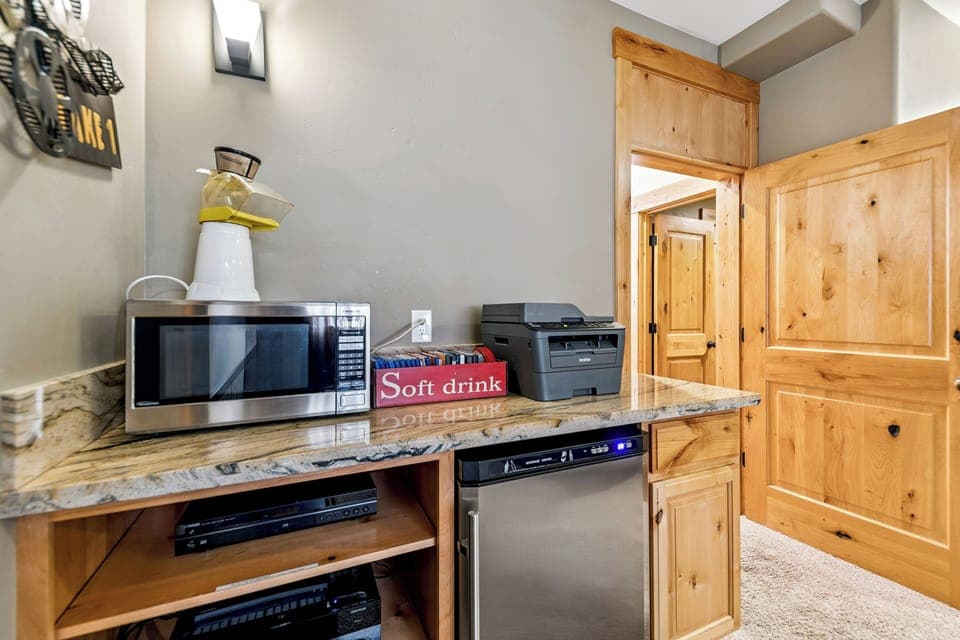 Popcorn maker, drink cooler, and stereo turn the theater room into a full movie night setup