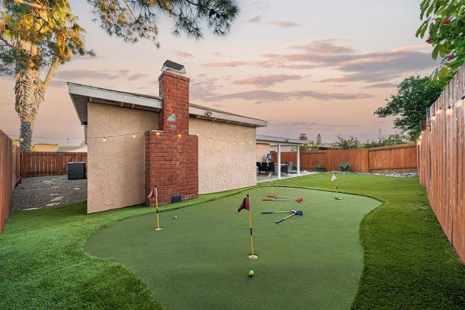 Fun backyard space featuring a mini golf setup for all ages.