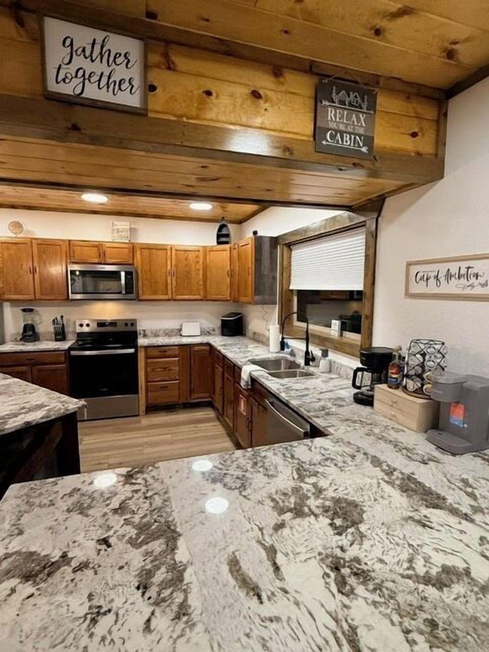 The large elegant gourmet kitchen is overflowing with granite countertop space, and is equipped with stainless steel appliances, dishes, utensils, cooking supplies and a complimentary coffee/tea bar!