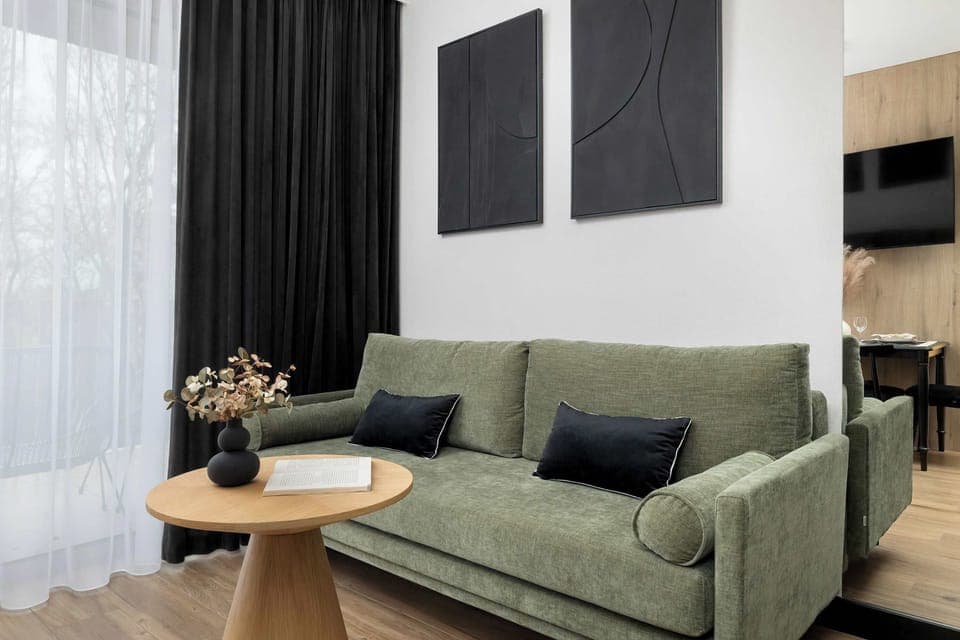 Relax in the stylish living room with a comfortable sofa and modern decor.