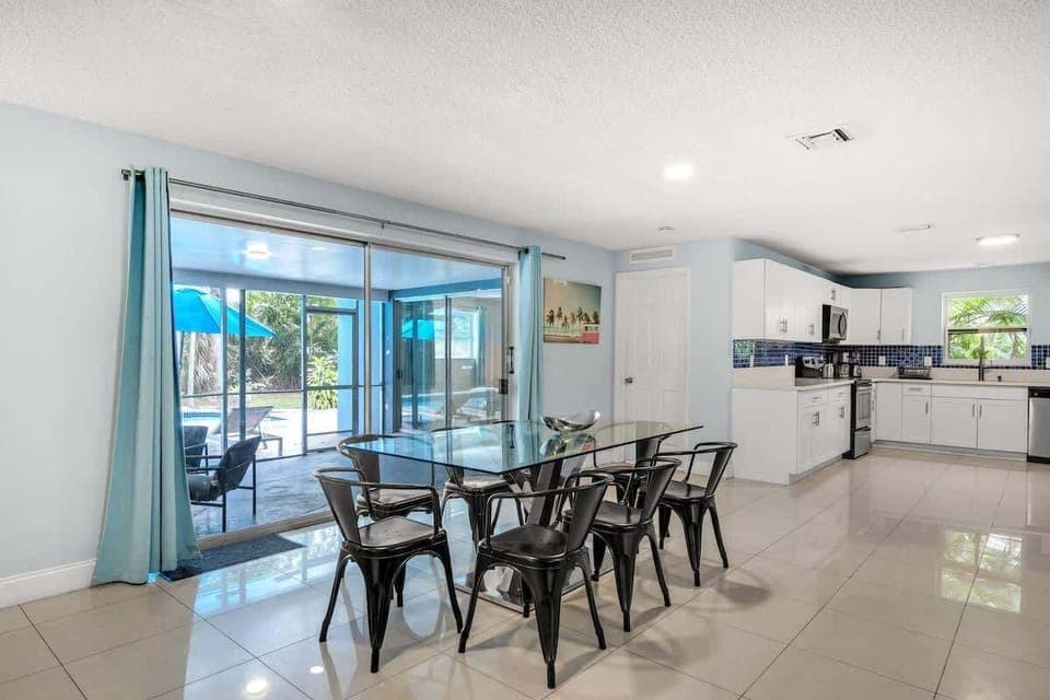 Cook, dine, and unwind in this open-concept kitchen with poolside views. Perfect for family meals and group stays in your vacation rental.