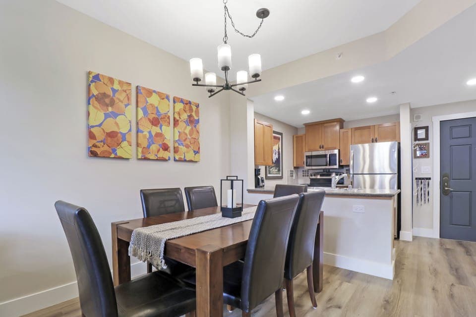 Gather around your elegant dining table for memorable meals, with a fully equipped kitchen featuring stainless steel appliances just steps away for your culinary adventures.