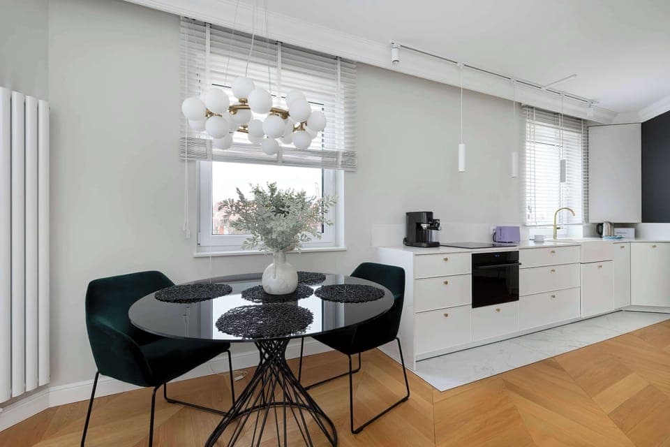 Inviting dining area with round table, modern chairs, and tasteful lighting.