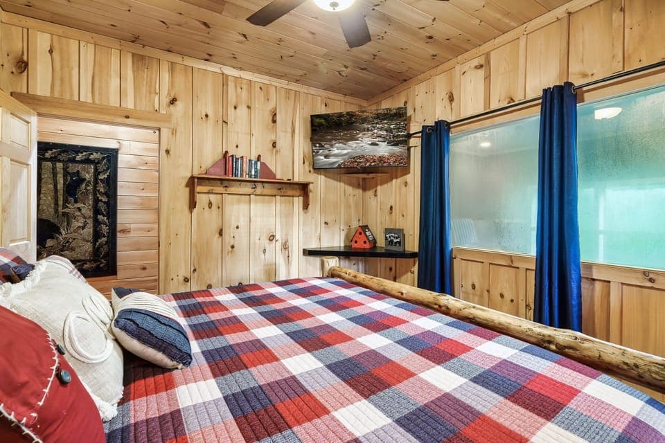 Peaceful bedroom retreat with wood finishes and large windows.